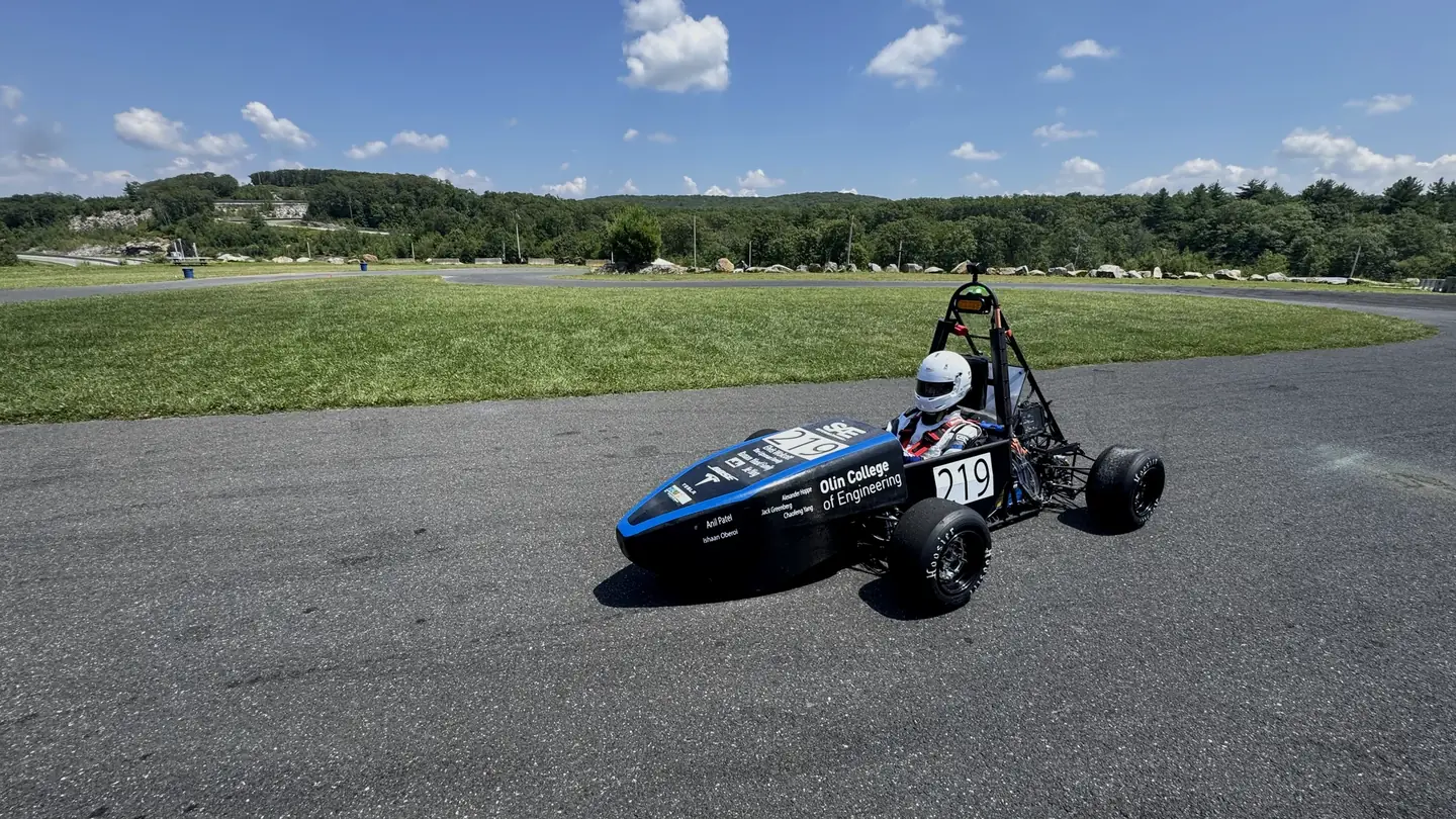 Kefan Wu at the wheel of Olin Electric Motorsports’ Formula SAE car on the test track.